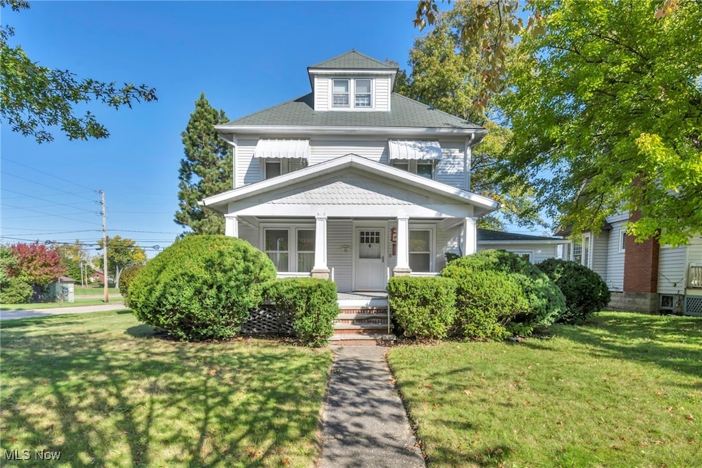 view of front of property with a front yard and covered porch