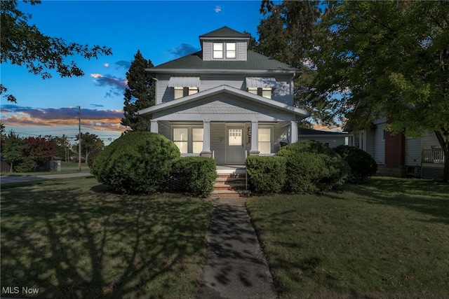 view of front facade featuring a lawn and a porch