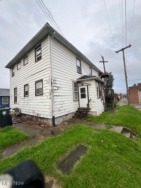 view of property exterior with a lawn