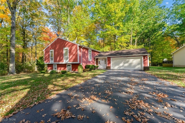 split level home featuring a front lawn and a garage