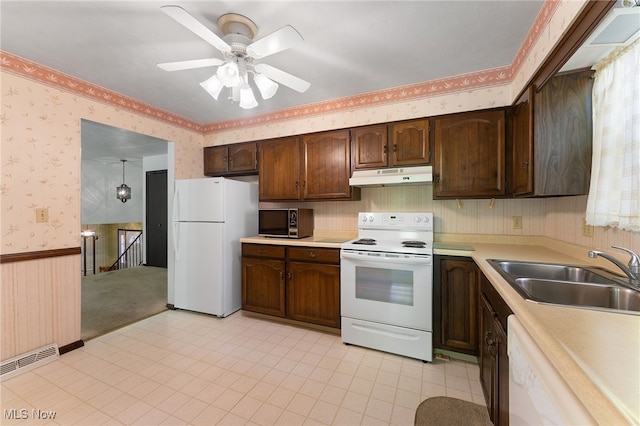 kitchen featuring white appliances, ceiling fan, dark brown cabinets, and sink