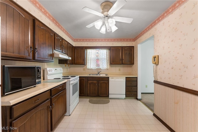 kitchen with white appliances, ceiling fan, dark brown cabinets, and sink