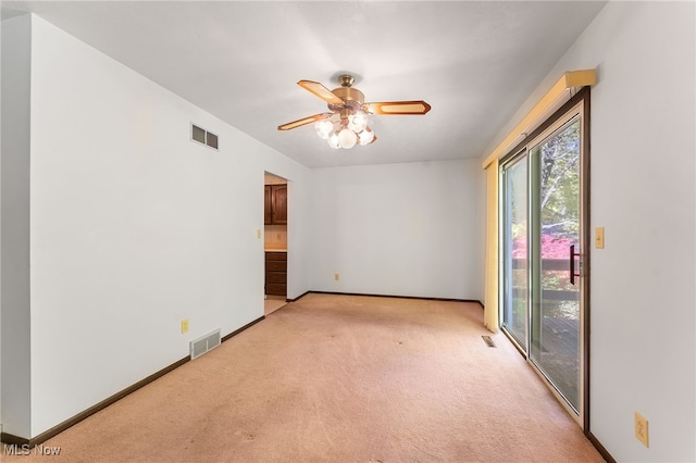 spare room with light carpet and ceiling fan