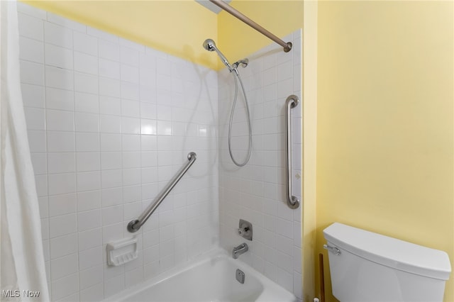 bathroom featuring toilet and shower / bath combination with curtain