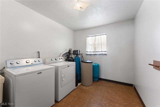 clothes washing area with washing machine and dryer