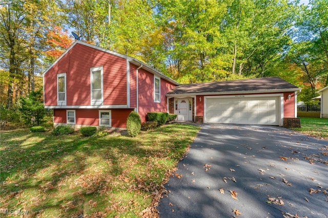 split level home featuring a front lawn and a garage