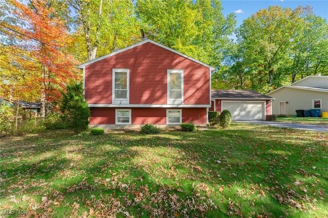 split level home with a front yard and a garage