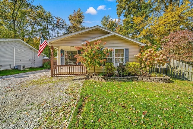 bungalow-style house with a front lawn, central air condition unit, and a porch