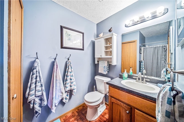 bathroom featuring vanity, curtained shower, toilet, and a textured ceiling