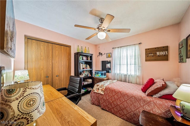 bedroom featuring carpet, ceiling fan, and a closet