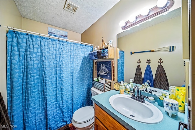 bathroom with vanity, a textured ceiling, a shower with curtain, and toilet