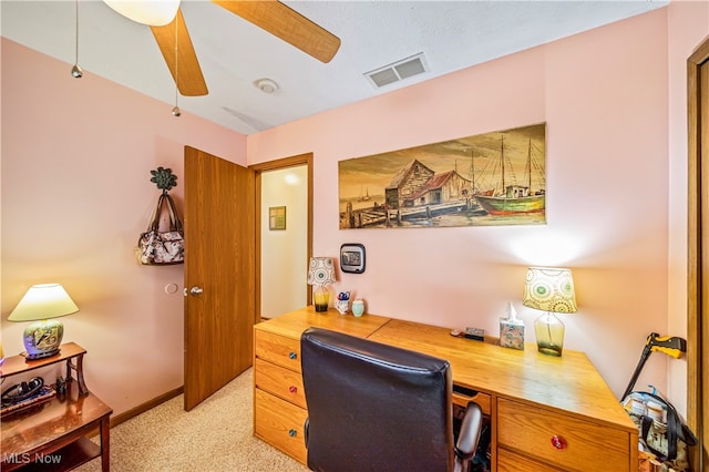 office space featuring ceiling fan and light carpet