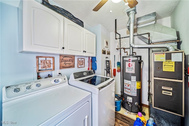 laundry room with water heater, cabinets, heating unit, washer and dryer, and a textured ceiling