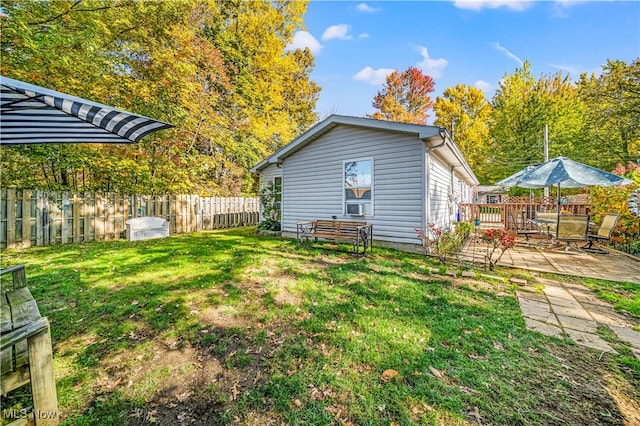 rear view of property featuring a wooden deck and a yard