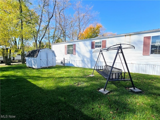 rear view of house with a storage shed and a lawn