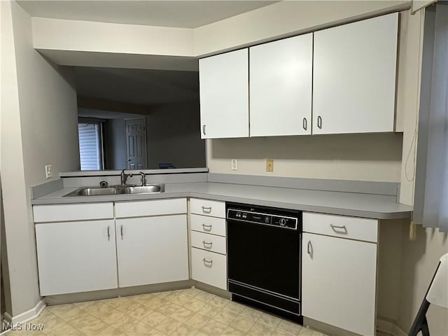 kitchen with white cabinetry, dishwasher, and sink