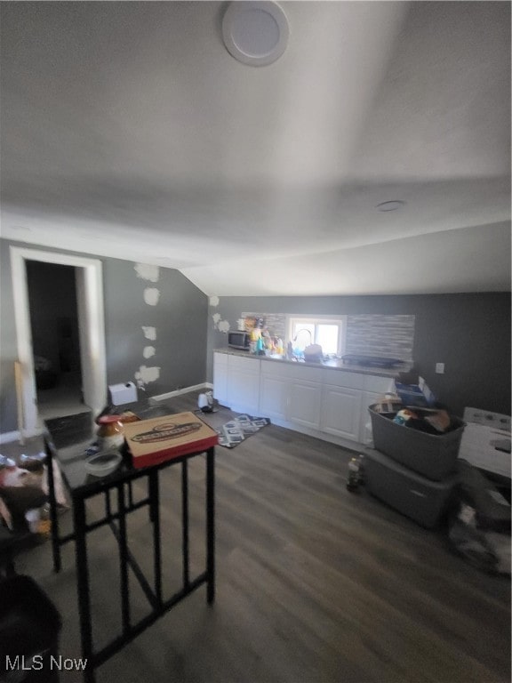 additional living space with lofted ceiling and dark wood-type flooring