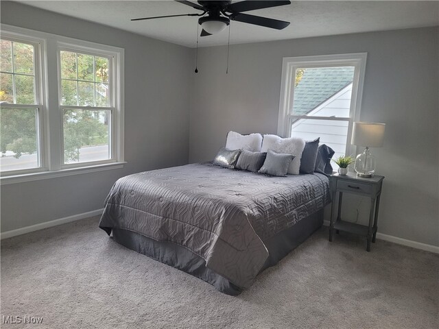 bedroom with ceiling fan and light carpet