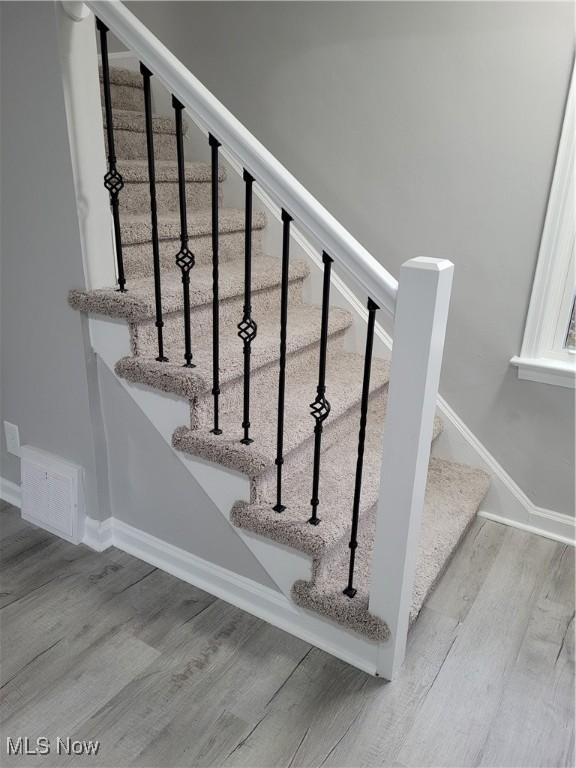 stairway with hardwood / wood-style flooring