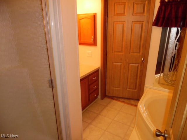 bathroom with vanity, shower with separate bathtub, and tile patterned flooring