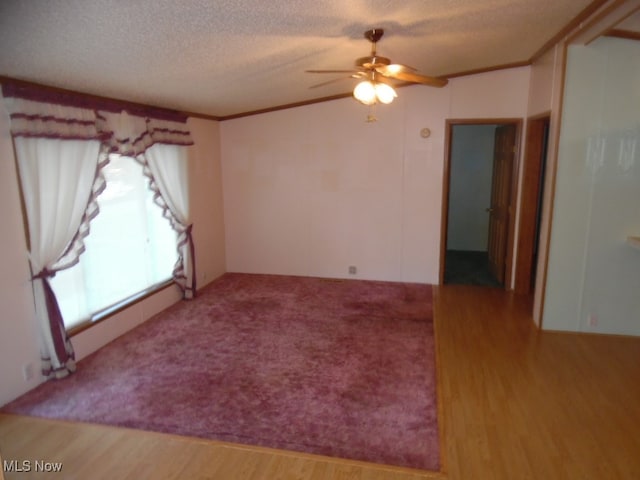 spare room featuring a textured ceiling, crown molding, hardwood / wood-style flooring, and ceiling fan