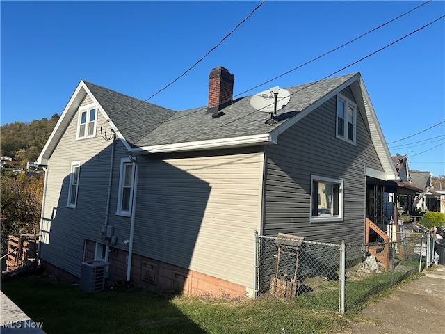 view of side of property with central AC unit