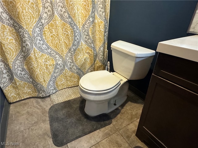 bathroom with vanity, toilet, and tile patterned flooring