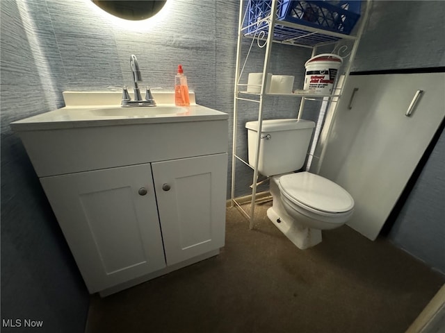 bathroom featuring vanity and toilet