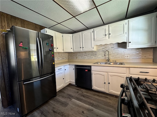 kitchen featuring dark hardwood / wood-style flooring, black appliances, sink, and white cabinets