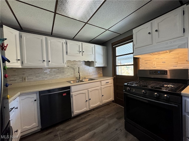 kitchen with sink, black appliances, white cabinetry, and a drop ceiling