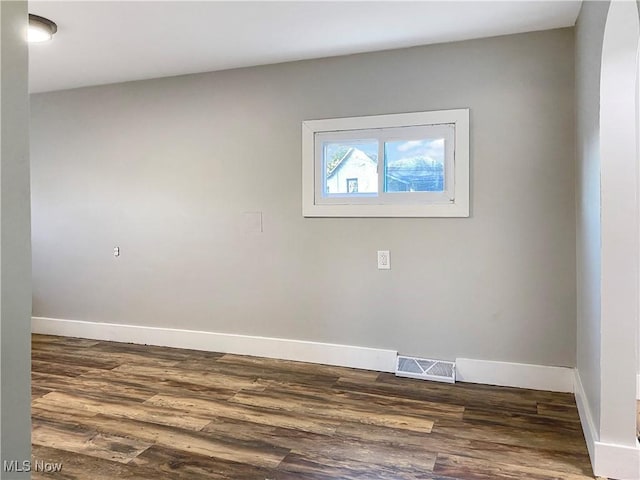 spare room featuring dark wood-type flooring