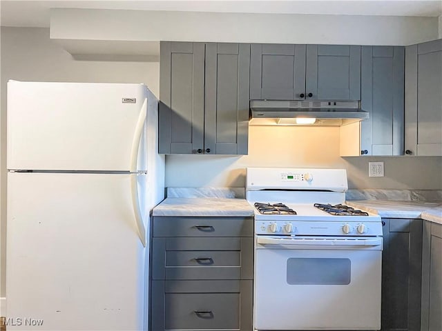 kitchen featuring white appliances and gray cabinetry