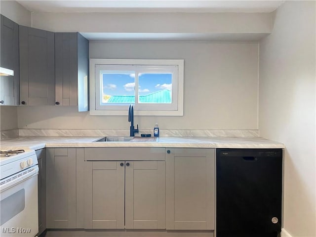 kitchen featuring gray cabinetry, sink, white range with gas stovetop, and black dishwasher