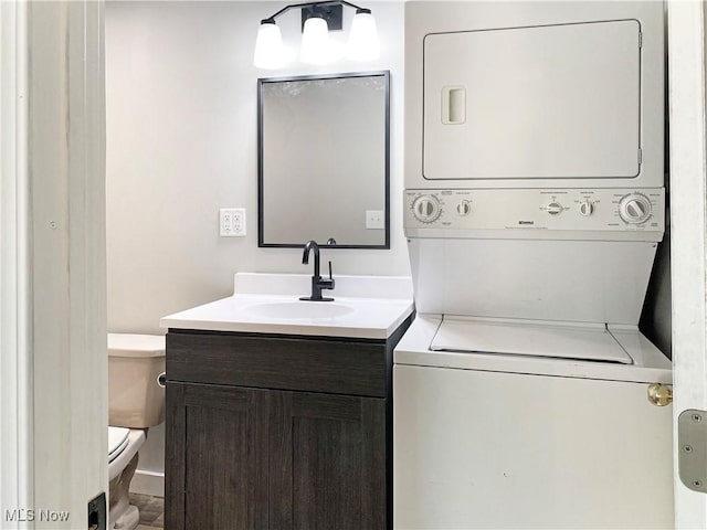 washroom with stacked washer and dryer and sink