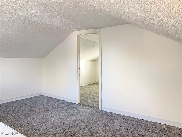 bonus room featuring carpet floors, a textured ceiling, and vaulted ceiling