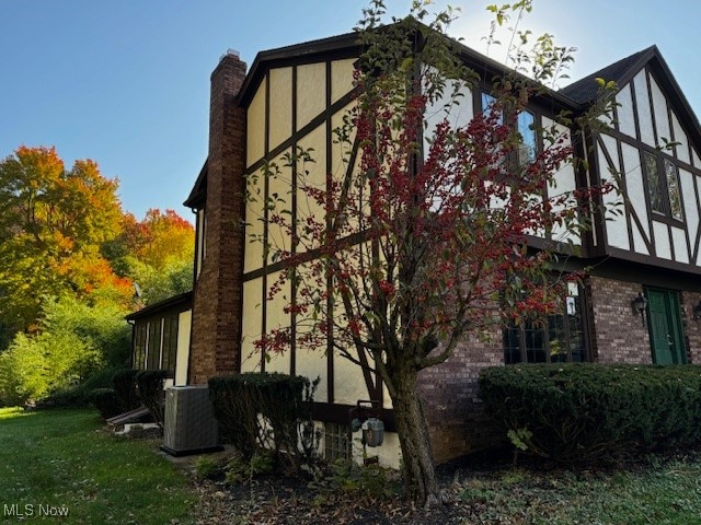 view of property exterior with central AC