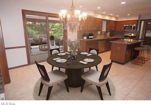 dining area featuring a notable chandelier and light tile patterned floors