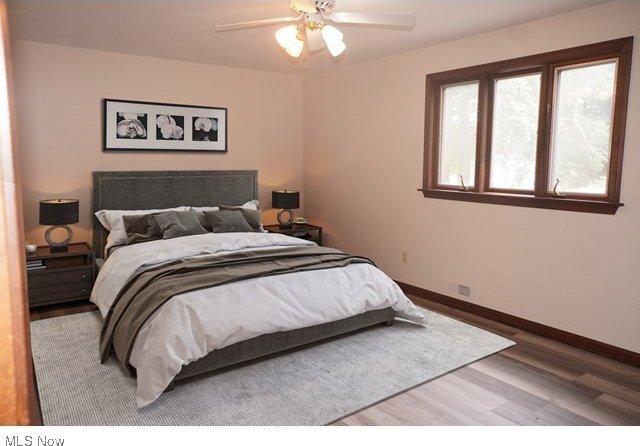 bedroom with ceiling fan and wood-type flooring