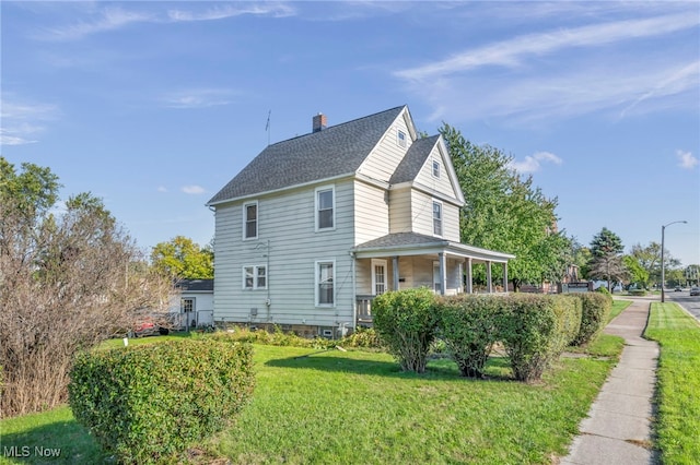 view of side of home with a lawn