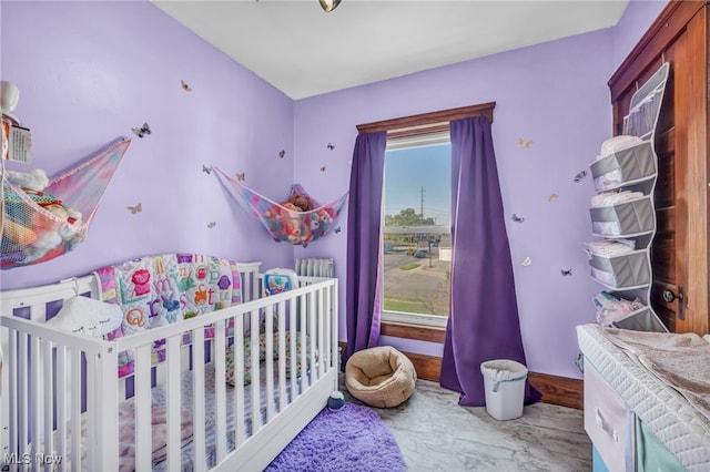 bedroom with a nursery area and multiple windows