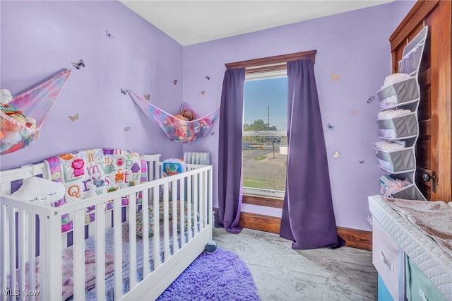 bedroom featuring a nursery area