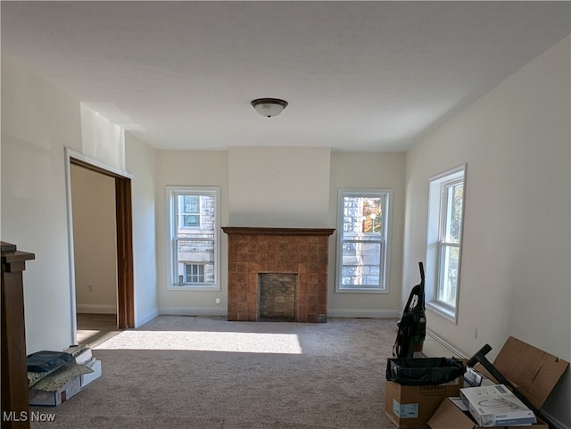 living room featuring light carpet and a tile fireplace