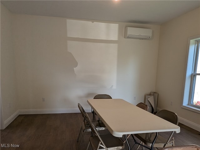 unfurnished dining area featuring dark wood-type flooring and a wall mounted AC