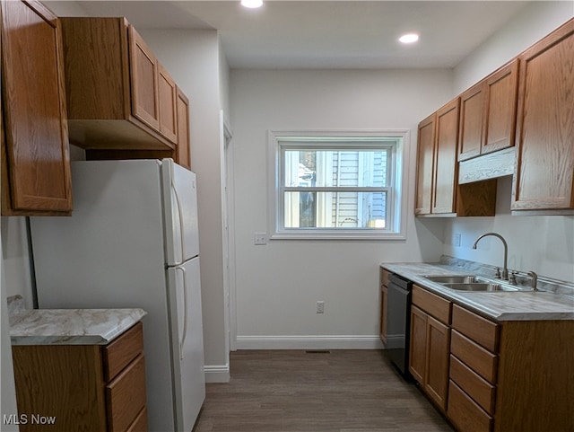 kitchen featuring black dishwasher, sink, white refrigerator, and dark hardwood / wood-style floors