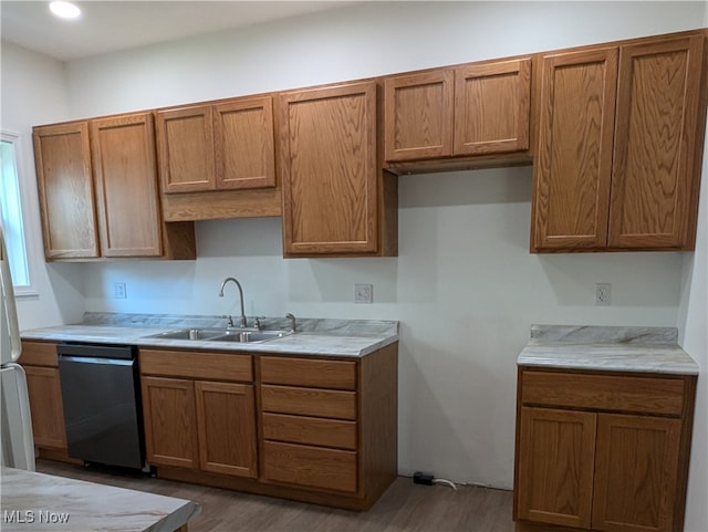 kitchen with sink, wood-type flooring, and dishwasher