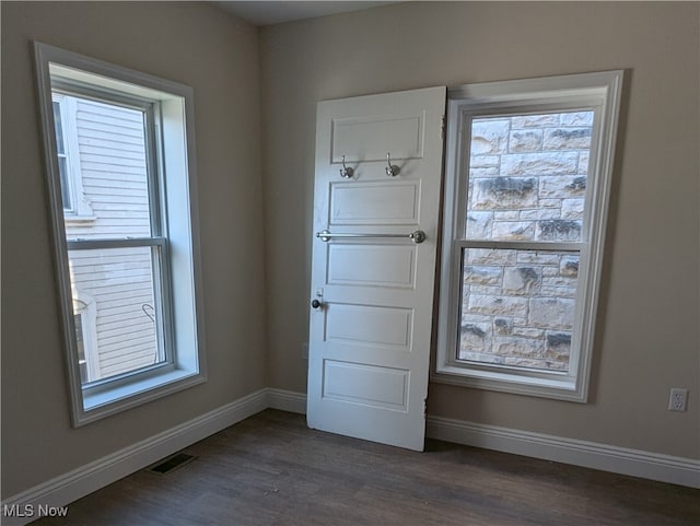 interior space with dark hardwood / wood-style floors