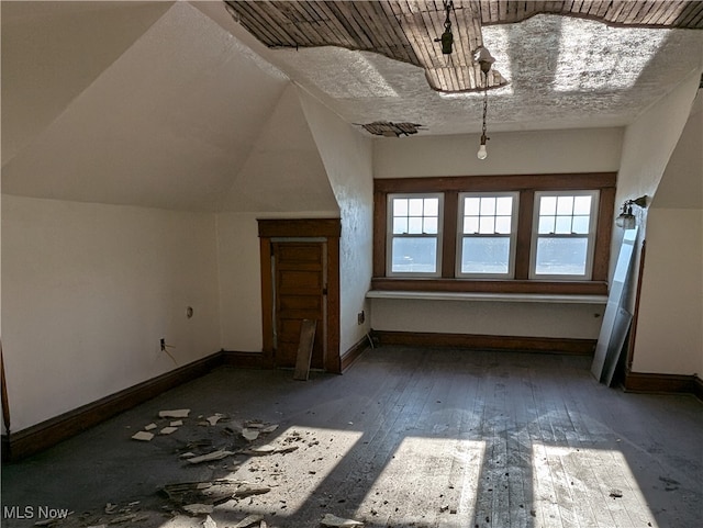 bonus room featuring vaulted ceiling and dark hardwood / wood-style floors