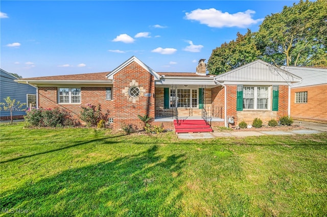 ranch-style house featuring covered porch and a front lawn