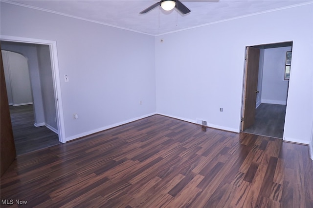 spare room featuring crown molding, dark hardwood / wood-style flooring, and ceiling fan