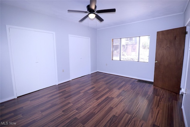 unfurnished bedroom featuring crown molding, dark hardwood / wood-style floors, and ceiling fan